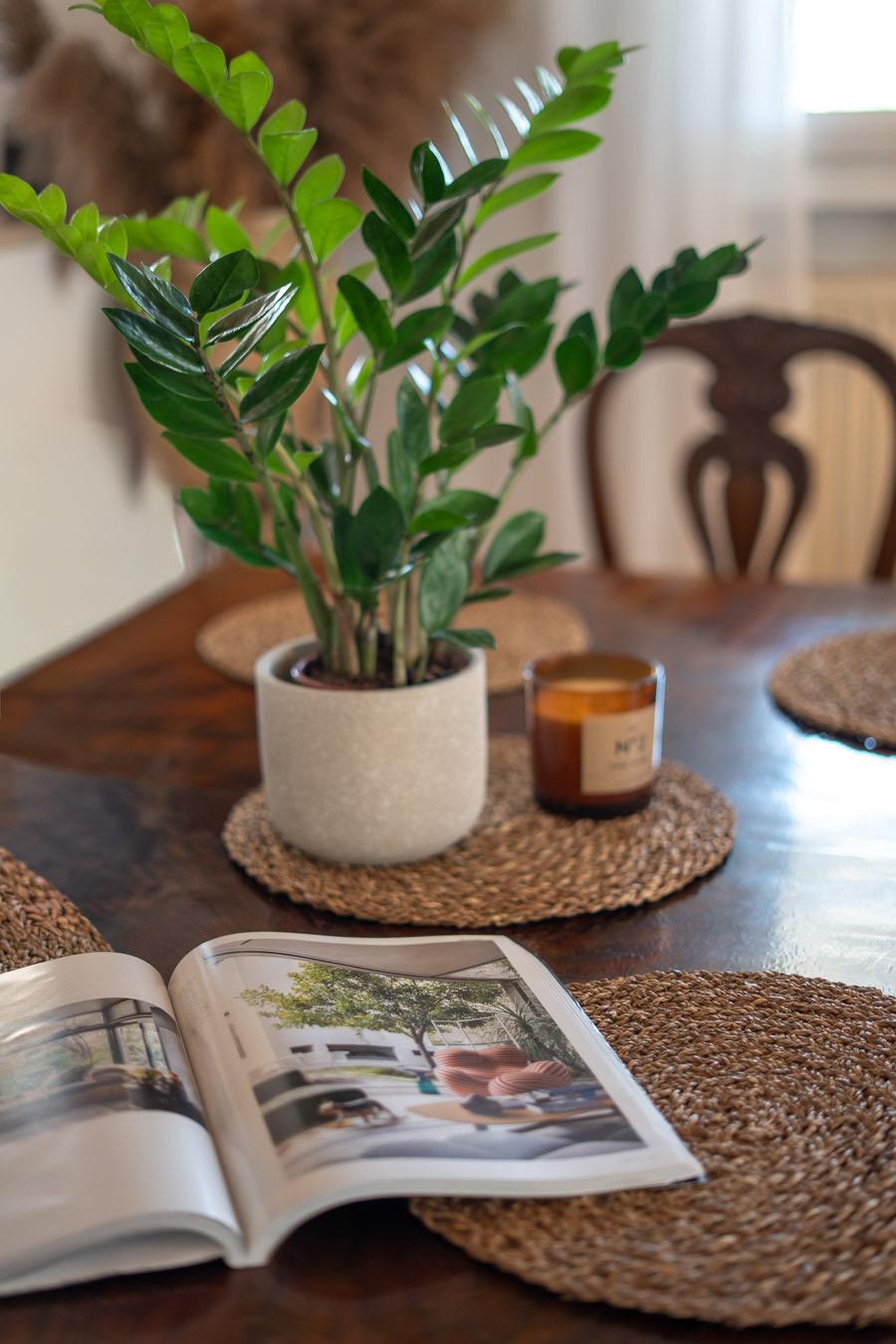 Dining table detail with plant and candle