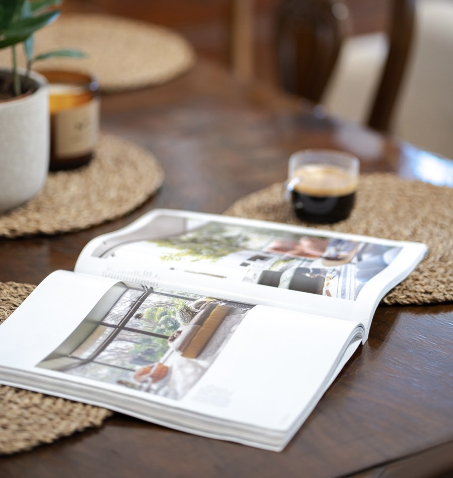 Dining table detail with magazine and coffee